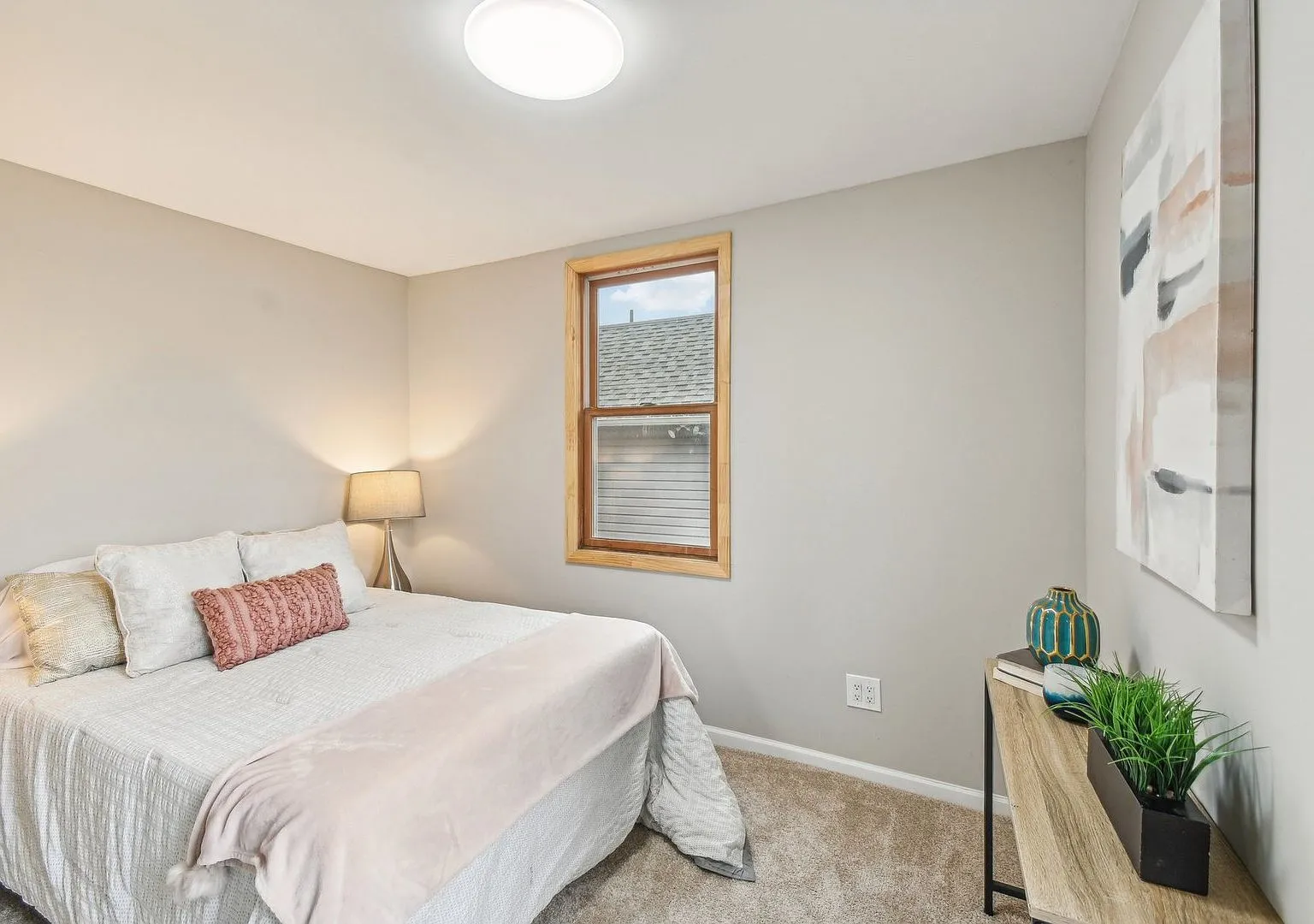 Staged bedroom with new carpet, renovated Lake Villa two-story