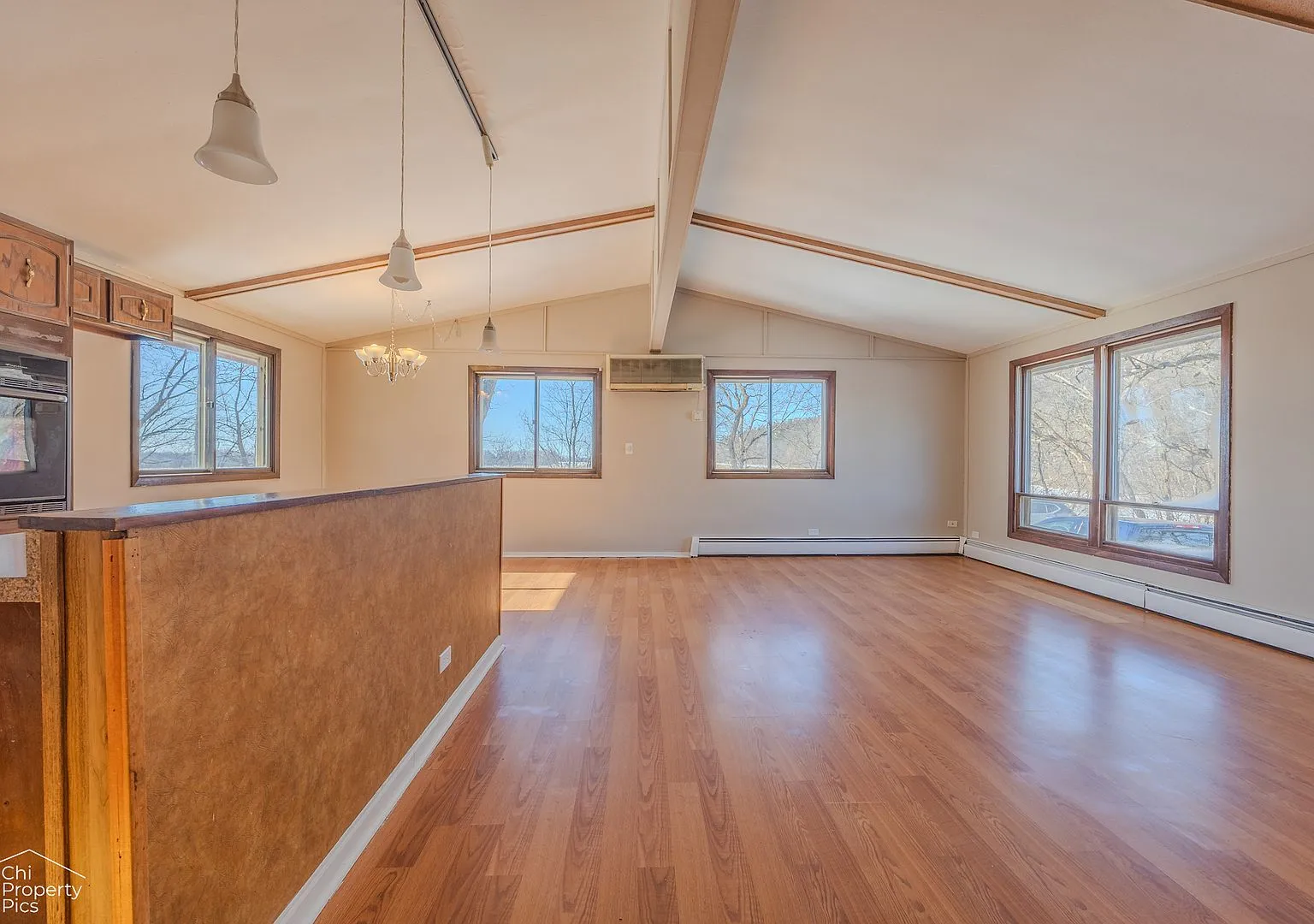 Vaulted living room with wood floors in original condition, McHenry IL case study