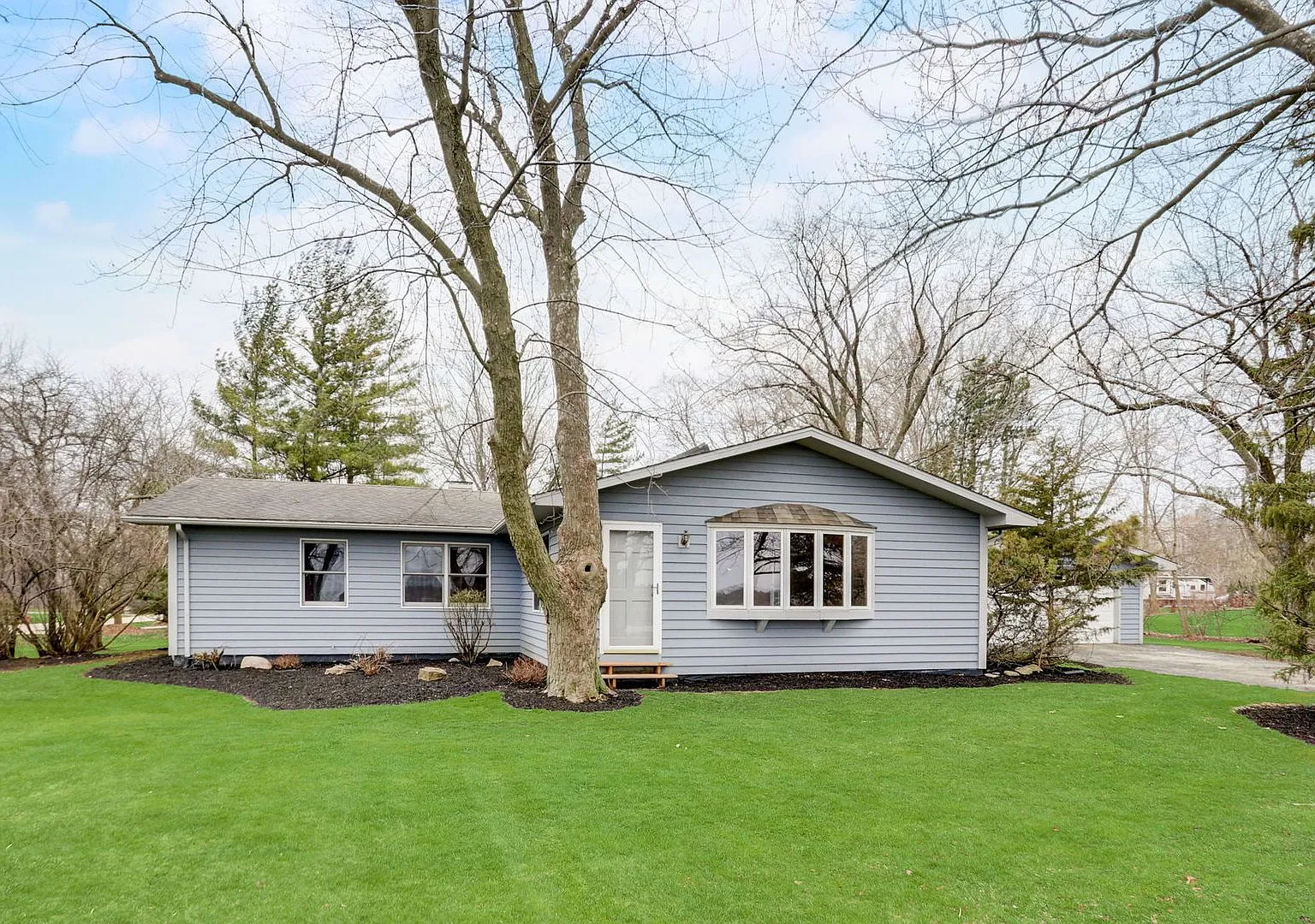 Front exterior of the 1955 ranch at 18871 W Casey Rd, Grayslake, IL on its large lot