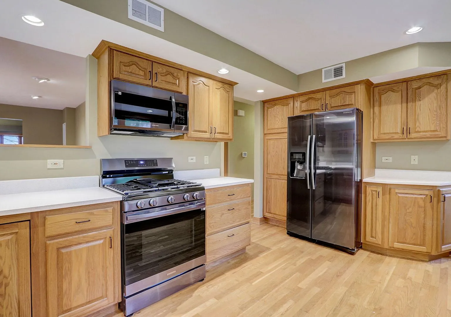 Oak kitchen with new white counters, island and stainless appliances, 18871 W Casey Rd