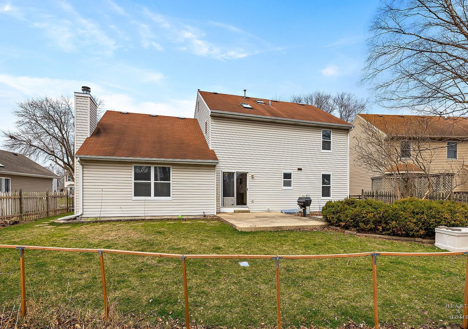Backyard and rear exterior of the Elgin two-story after cleanup