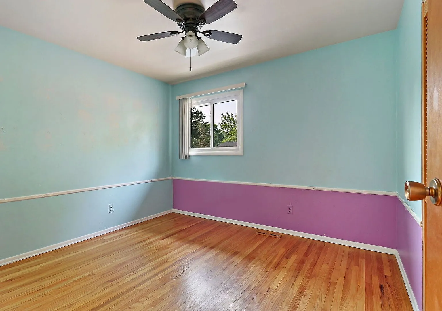Bedroom with two-tone paint and hardwood floors, 1968 Crystal Lake home
