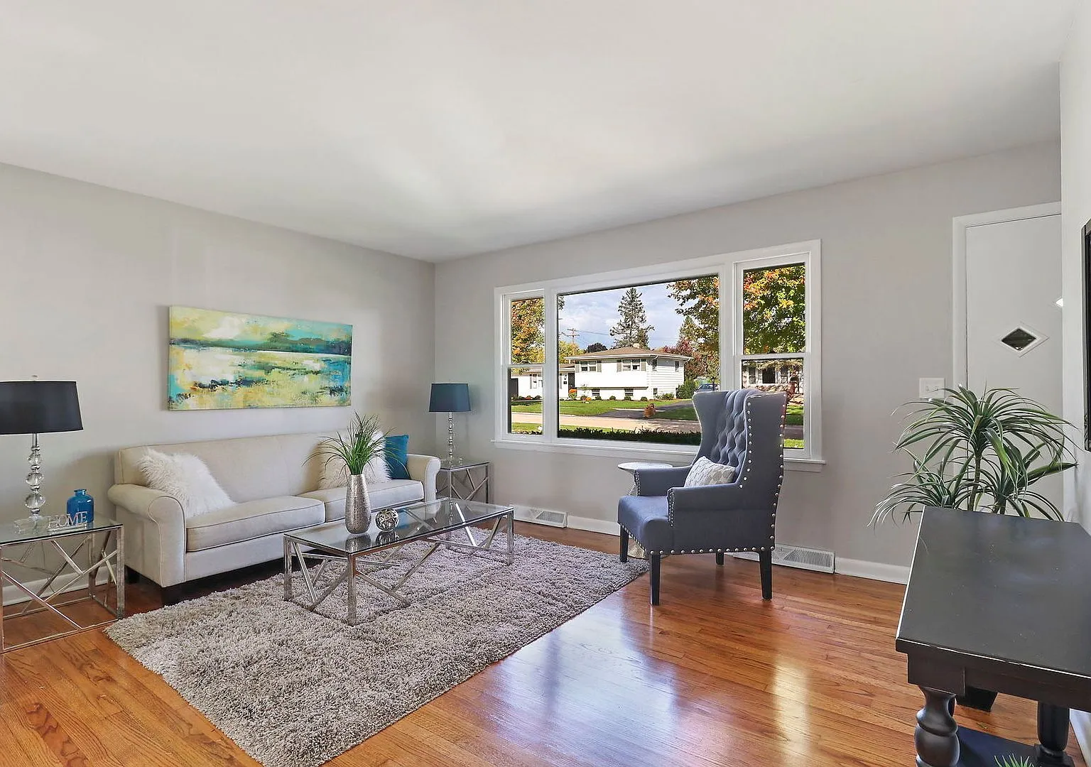 Staged living room with refinished hardwood, Cary IL case study