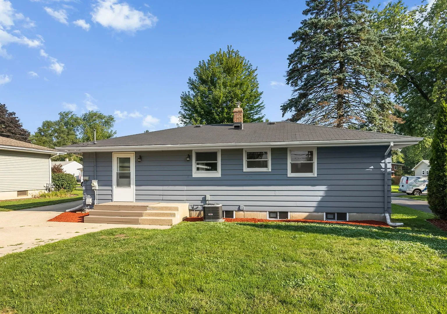 Rear exterior and yard of the Cary ranch after renovation