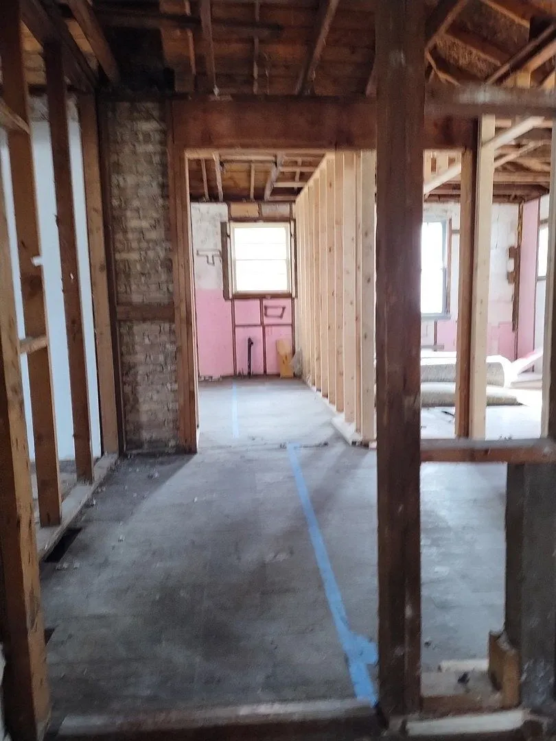 Gutted room with exposed framing and insulation, 207 S Highland Dr Lakemoor