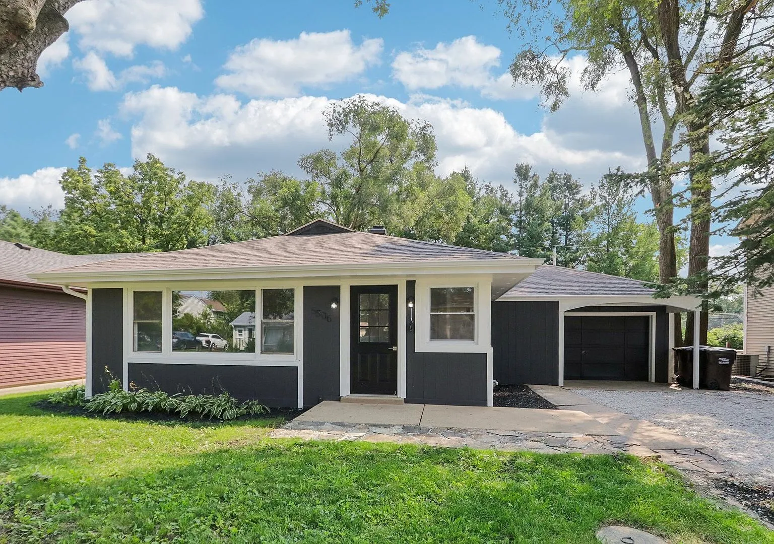 Front exterior of the renovated 1960 ranch at 5506 Oakwood Dr, Cary, IL with new dark exterior paint