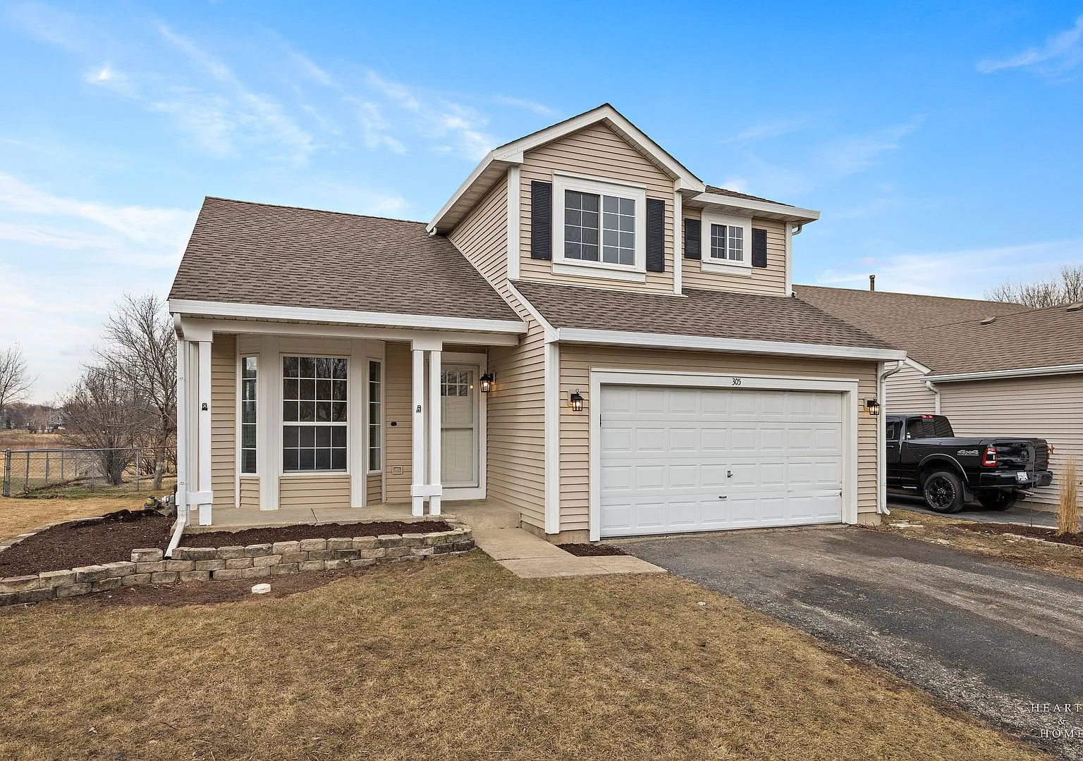 Front exterior of the two-story home at 305 Harvest Gate Rd, Lake in the Hills, IL