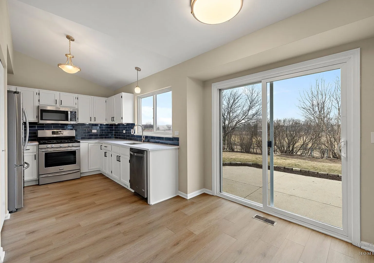 Refreshed kitchen with painted cabinets, new blue tile backsplash and stainless appliances, Lake in the Hills IL