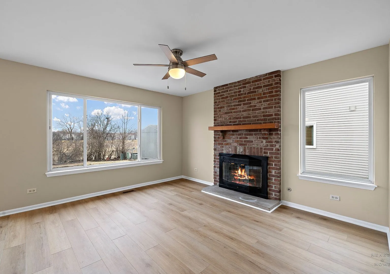 Family room with brick fireplace and new luxury vinyl plank flooring, 305 Harvest Gate Rd
