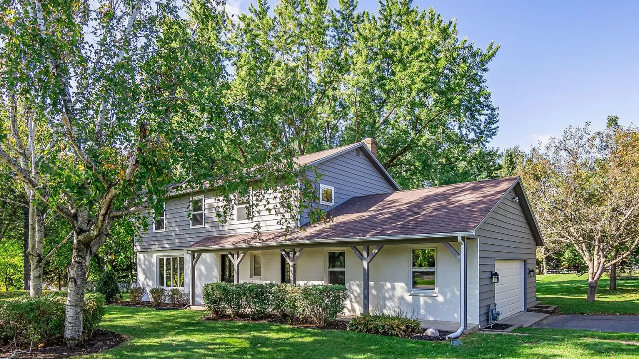A 1974 two-story home on a treed lot in Woodstock, IL sold during pre-foreclosure
