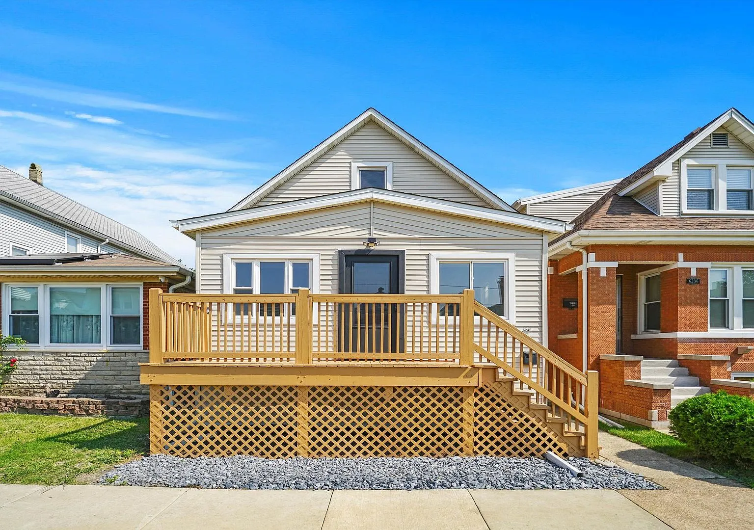 Front exterior of the renovated 1922 home at 6240 W Berenice Ave, Portage Park, Chicago with new deck