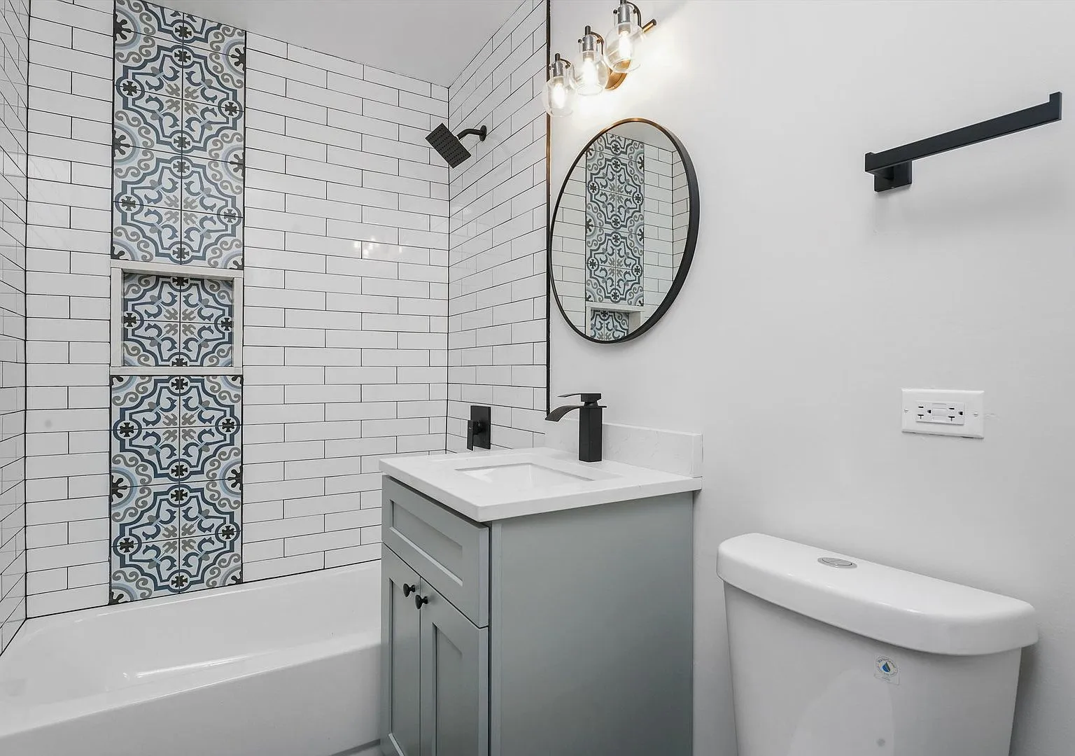 Remodeled bathroom with patterned tile accent and new vanity, 6240 W Berenice Ave Chicago