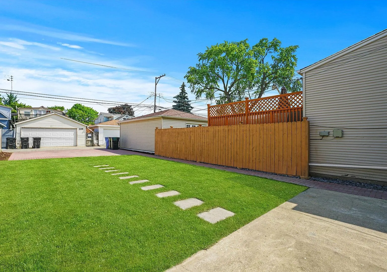 Backyard with new lawn and fence at the renovated Portage Park home