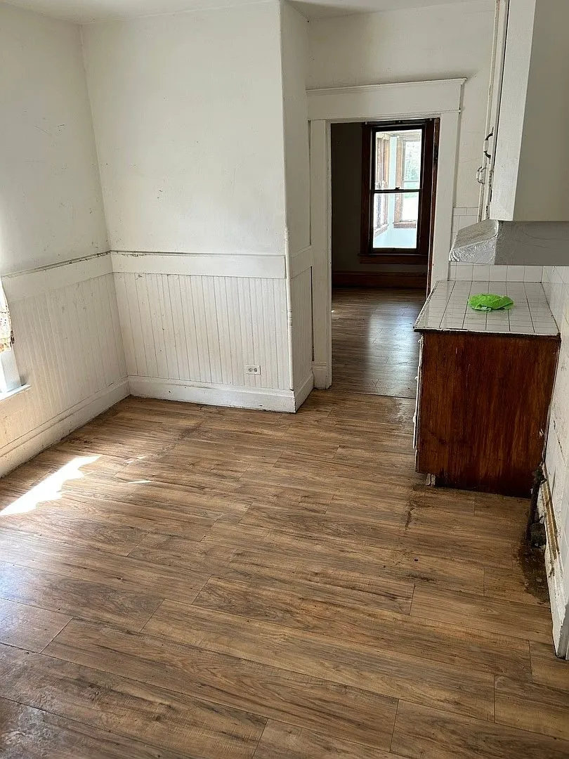 Worn interior room with aged flooring, Zion IL rental as purchased